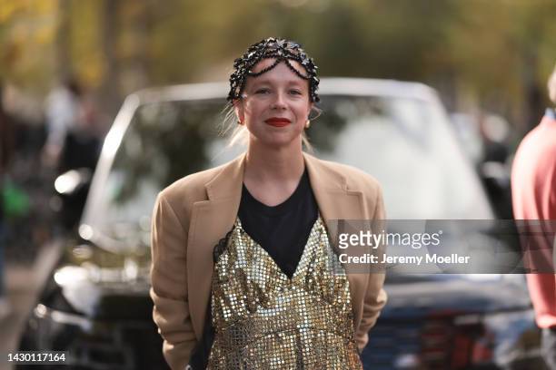 Fashion Week Guest seen wearing a brown coat, a golden dress and black shirt and black hair details outside Ellie Saab during Pariser Fashion Week on...
