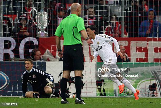 Mesut Oezil of Real Madrid celebrates the first goal against Manuel Neuer of Bayern during the UEFA Champions League Semi Final first leg match...