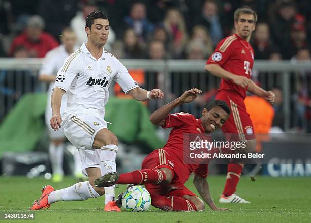 Luiz Gustavo of Bayern Muenchen fights for the ball with Cristiano Ronaldo of Real Madrid during the UEFA Champoins League Semi Final first leg match...