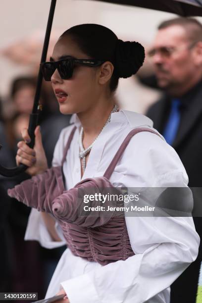 Fashion week guest seen wearing celine shades and bulgari jewellery, outside Givenchy during Paris Fashion Week on October 02, 2022 in Paris, France.