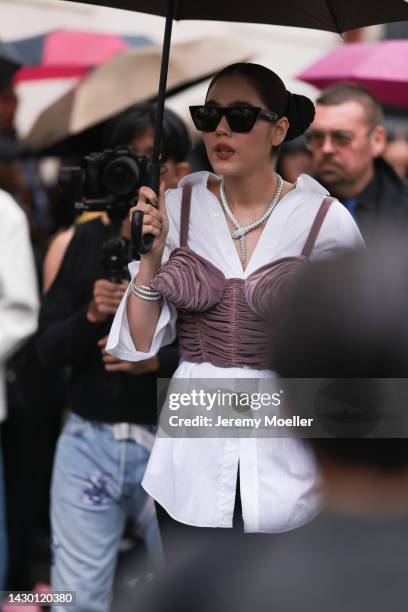 Fashion week guest seen wearing celine shades and bulgari jewellery, outside Givenchy during Paris Fashion Week on October 02, 2022 in Paris, France.