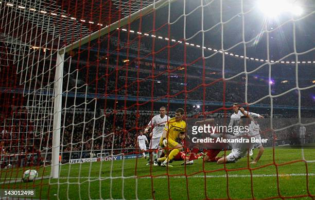 Mario Gomez of Bayern Muenchen scores his first goal against goalkeeper Iker Casillas and Alvaro Arbeloa of Real Madrid during the UEFA Champoins...
