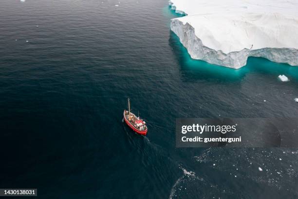 fishing boat in front of icebergs, disko bay, greenland - atlantic ocean bildbanksfoton och bilder