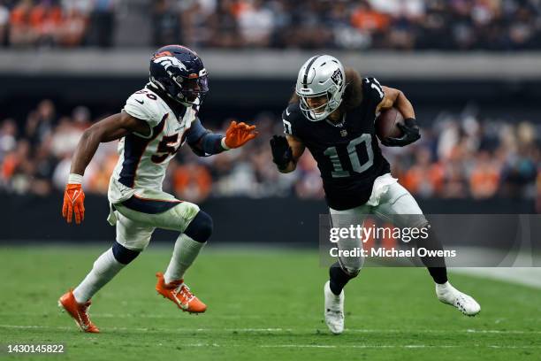 Mack Hollins of the Las Vegas Raiders runs against Jonas Griffith of the Denver Broncos during an NFL football game between the Las Vegas Raiders and...