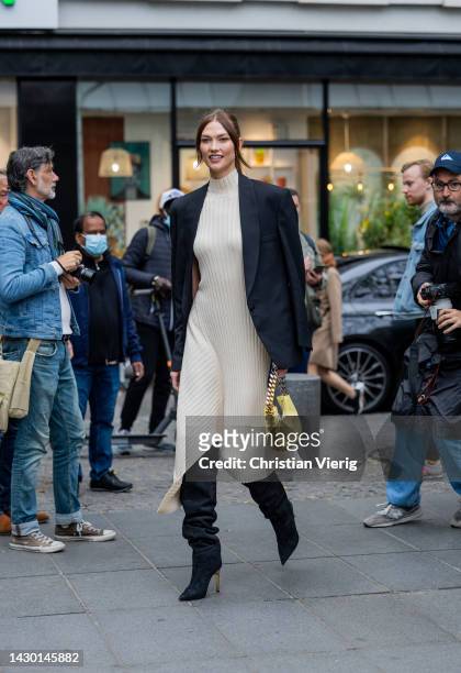 Karlie Kloss wears knitted latte dress, black blazer, yellow bag, boots outside Stella McCartney during Paris Fashion Week - Womenswear Spring/Summer...