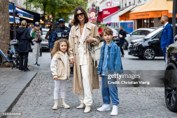 Golestaneh Mayer-Ullner with children wears beige coat outside Stella McCartney during Paris Fashion Week - Womenswear Spring/Summer 2023 : Day Eight...