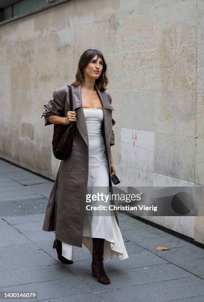 Jeanne Damas wears leather coat, white pants outside Stella McCartney during Paris Fashion Week - Womenswear Spring/Summer 2023 : Day Eight on...