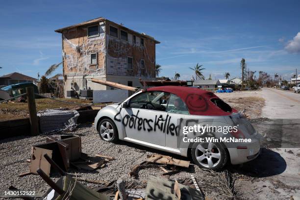 Warning to looters is painted on the side of a car destroyed during Hurricane Ian on October 03, 2022 in Pine Island, Florida. Southwest Florida...