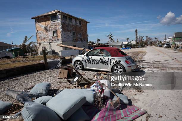 Warning to looters is painted on the side of a car destroyed during Hurricane Ian on October 03, 2022 in Pine Island, Florida. Southwest Florida...