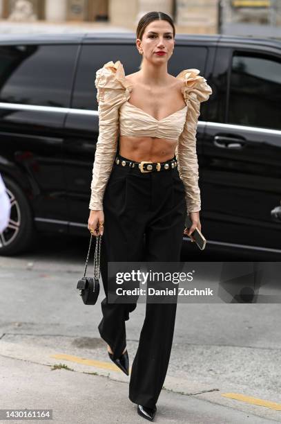 Cassandra Dimicco is seen wearing a cream ruffled Zimmermann cropped blouse, black pants, black and gold belt and black bag outside the Zimmermann...