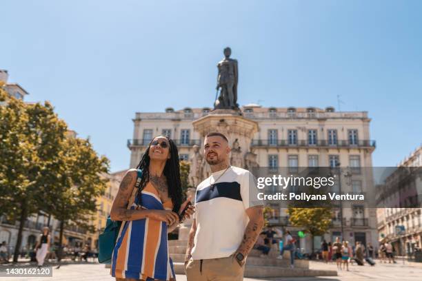 young people enjoying a sunny day at praça luís de camões in lisbon - tourism in lisbon stock pictures, royalty-free photos & images