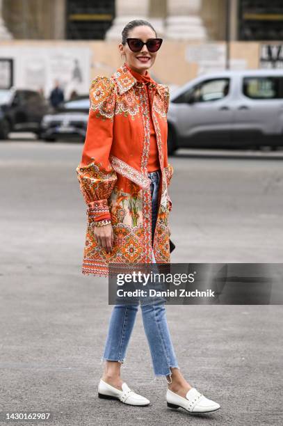 Olivia Palermo is seen wearing an orange Zimmermann jacket, blue jeans and white shoes and black sunglasses outside the Zimmermann show during Paris...