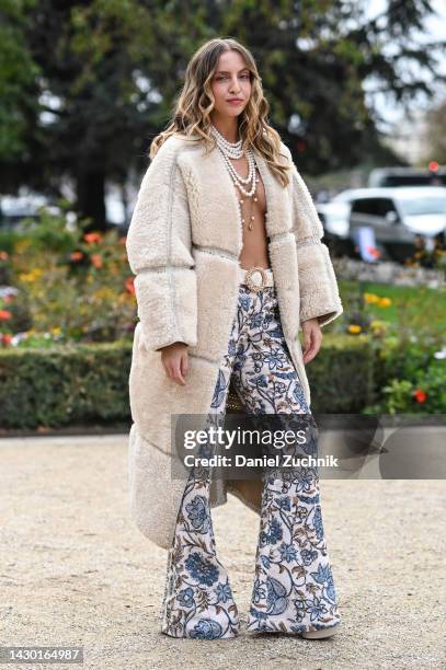 Carla Ginola is seen wearing a faux fur cream coat, blue and cream floral pants and a pearl necklace outside the Zimmermann show during Paris Fashion...