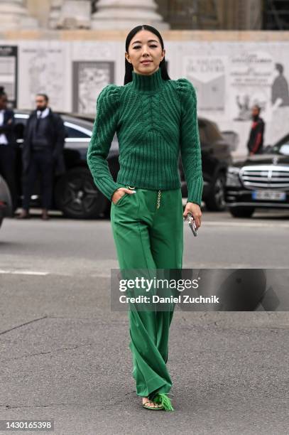 Yuwei Zhangzou is seen wearing a green sweater, green pants, green faux fur shoes and gold chain belt outside the Zimmermann show during Paris...