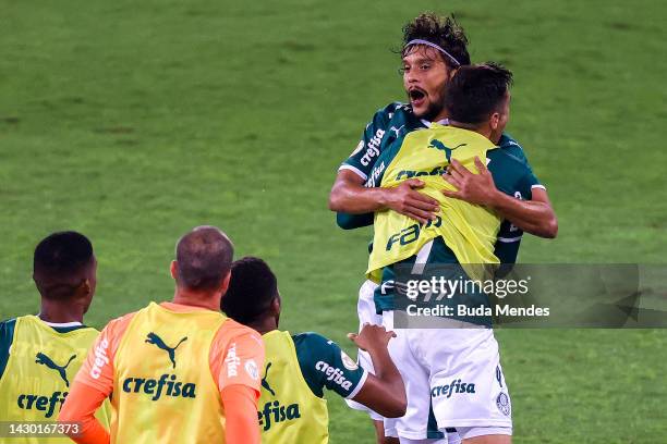 Gustavo Scarpa of Palmeiras celebrates with teammates after scoring the first goal of their team during the match between Botafogo and Palmeiras as...