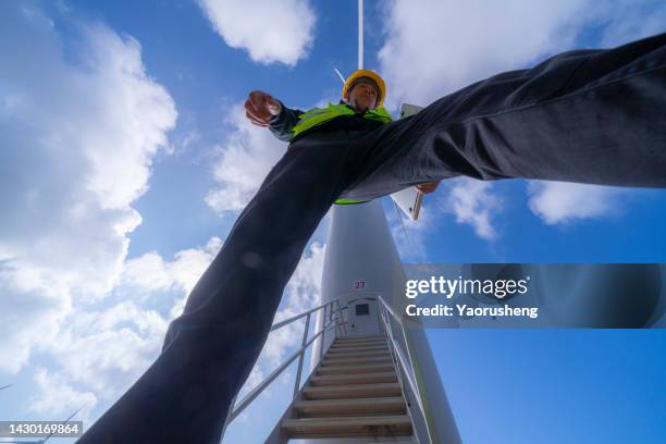 one asian young maintenance engineer man working on wind turbine farm - laptop high up stock pictures, royalty-free photos & images