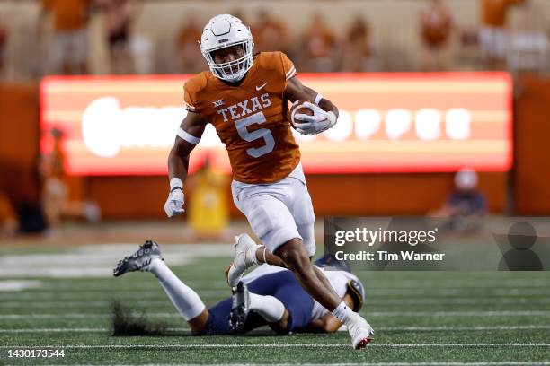 Bijan Robinson of the Texas Longhorns runs past a West Virginia Mountaineers defender in the second half at Darrell K Royal-Texas Memorial Stadium on...