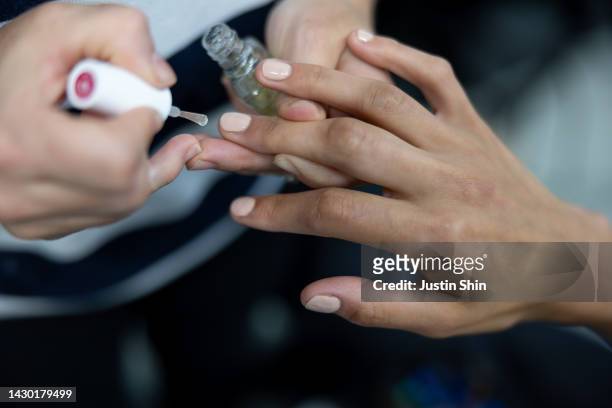 Model gets nails done in the backstage prior to the Germanier Womenswear Spring/Summer 2023 show as part of Paris Fashion Week on October 03, 2022 in...