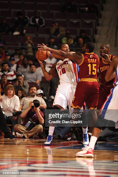 Greg Monroe of the Detroit Pistons protects the ball from Donald Sloan of the Cleveland Cavaliers during the game between the Detroit Pistons and the...