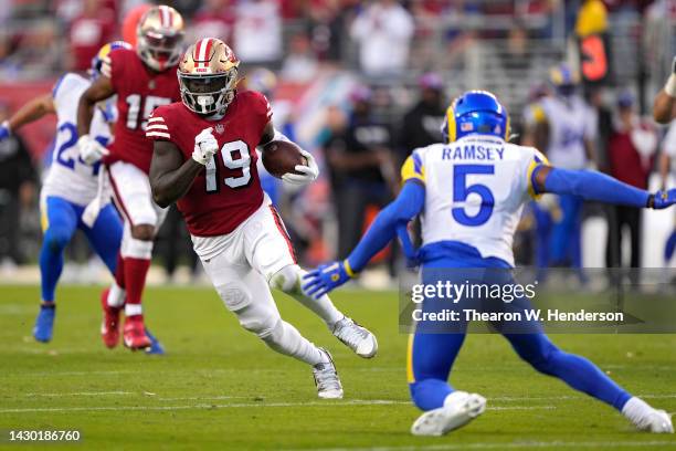 Wide receiver Deebo Samuel of the San Francisco 49ers rushes for a touchdown as he breaks a tackle by cornerback Jalen Ramsey of the Los Angeles Rams...