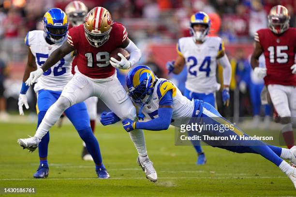 Wide receiver Deebo Samuel of the San Francisco 49ers rushes for a touchdown as he breaks a tackle by cornerback Jalen Ramsey of the Los Angeles Rams...