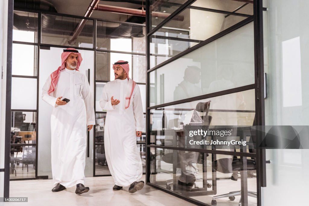 Riyadh professionals walking to meeting in modern office