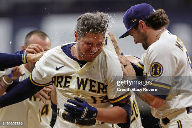 Hunter Renfroe of the Milwaukee Brewers is congratulated by teammates following a walk off RBI single against the Arizona Diamondbacks during the...