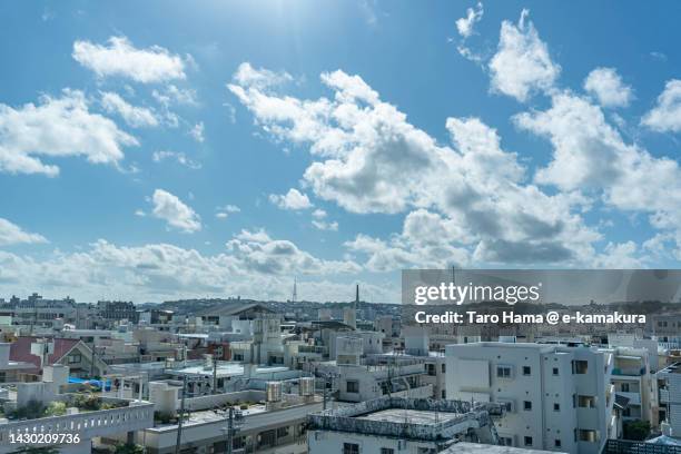 summer clouds over the residential district in naha city of japan - okinawa japan stockfoto's en -beelden
