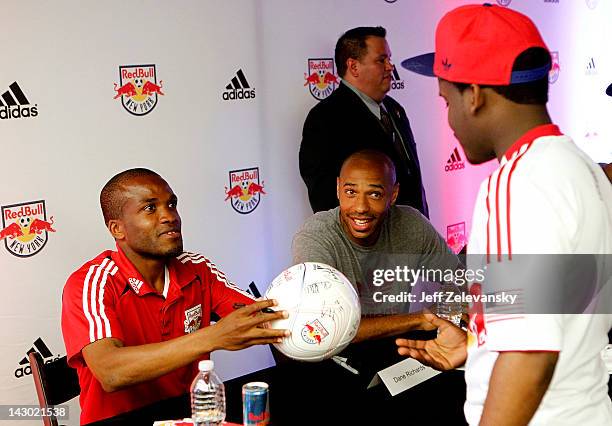 Midfielder/forward Dane Richards and forward Thierry Henry of the New York Red Bulls greet fans at an autograph signing at the adidas Sport...
