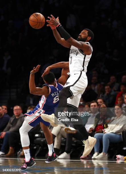 Kyrie Irving of the Brooklyn Nets and De'Anthony Melton of the Philadelphia 76ers fight for the ball in the first half during a preseason game at...
