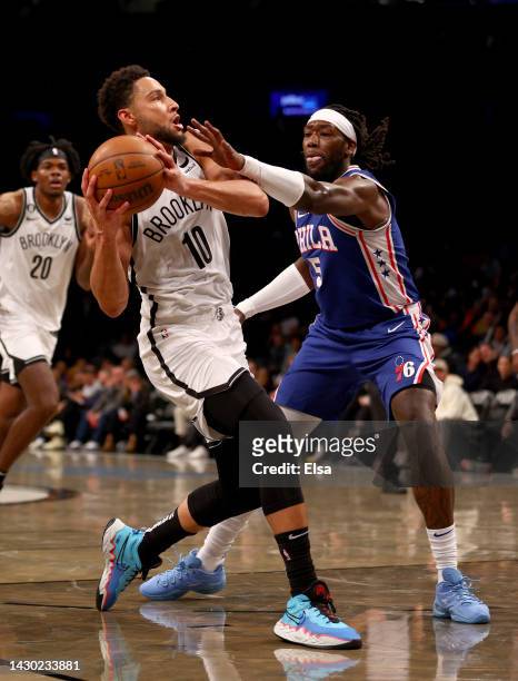 Ben Simmons of the Brooklyn Nets heads for the net as Montrezl Harrell of the Philadelphia 76ers defends during a preseason game at Barclays Center...