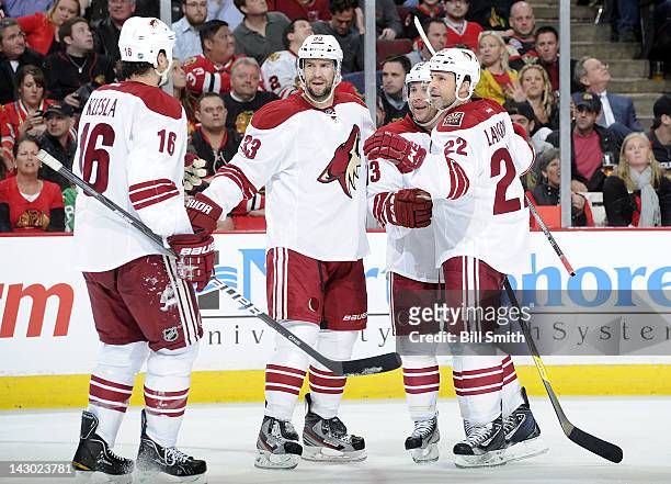Rostislav Klesla of the Phoenix Coyotes skates over to celebrate with teammates Adrian Aucoin, Ray Whitney, and Daymond Langkow after the Coyotes...