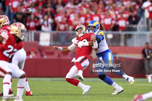 Quarterback Jimmy Garoppolo of the San Francisco 49ers takes a hit by defensive tackle Aaron Donald of the Los Angeles Rams during the first quarter...