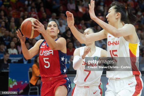 United States' Kelsey Plum is challenged by China's Yang Liwei and Han Xu during the 2022 FIBA Women's Basketball World Cup Final match between USA...