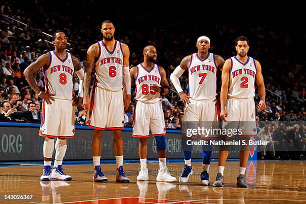 New York Knicks players J.R. Smith, Tyson Chandler, Baron Davis, Carmelo Anthony and Landry Fields stand on court during a break in action against...