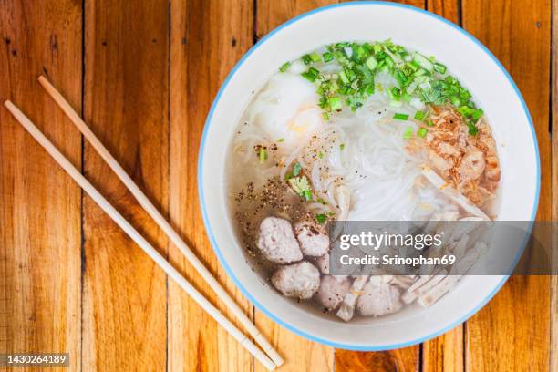 traditional vietnamese noodles served in a bowl on a wooden table. - pho suppe stock-fotos und bilder