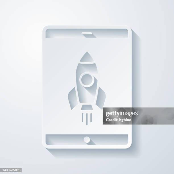 tablet pc with rocket. icon with paper cut effect on blank background - 3d rocket launch stock illustrations