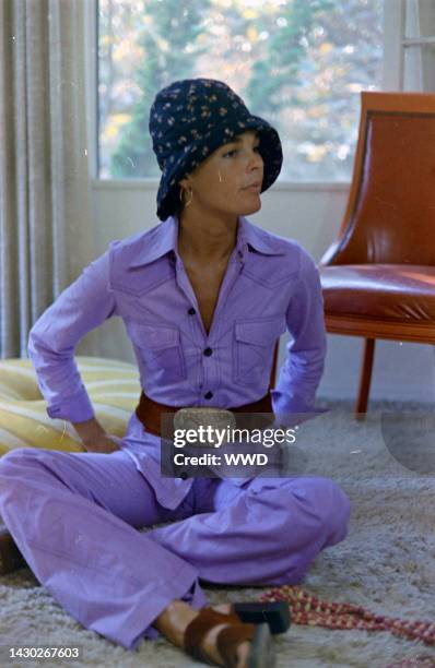 Actress Ali MacGraw sits on rug and answers questions during an interview in her friend's apartment.