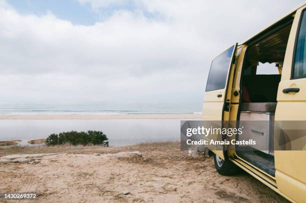 camper van parked on the beach - südeuropa stock-fotos und bilder