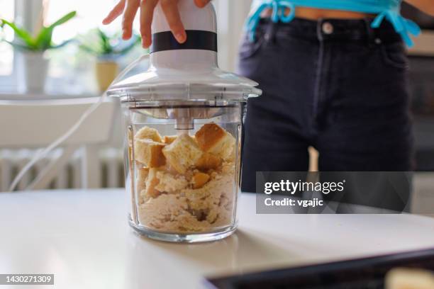grinding down bread in the food processor. - breadcrumbs stock pictures, royalty-free photos & images