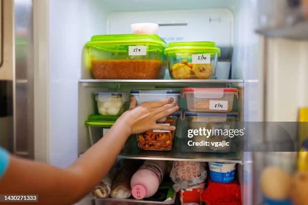 food leftovers packaged in boxes inside a home fridge - refrigerator stock pictures, royalty-free photos & images