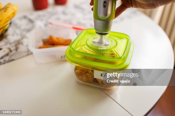 packing food leftovers in vacuum box - vacuum packed bildbanksfoton och bilder