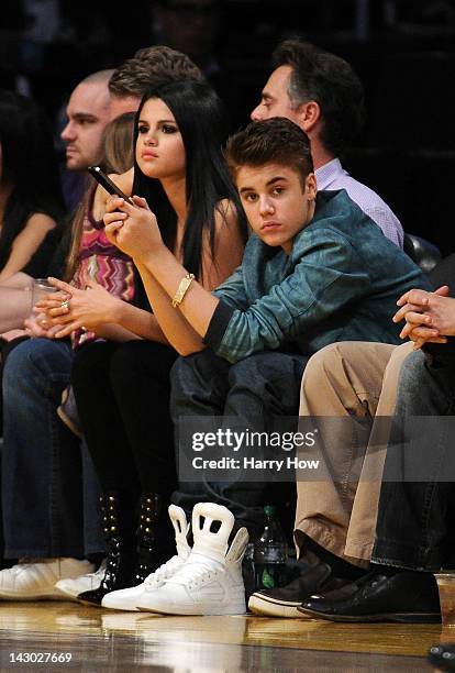 Justin Beiber and girlfriend Selena Gomez watch the game between the San Antonio Spurs and the Los Angeles Lakers at Staples Center on April 17, 2012...