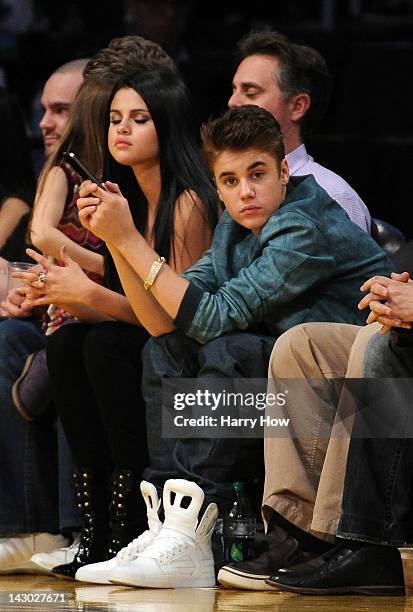 Justin Beiber and girlfriend Selena Gomez watch the game between the San Antonio Spurs and the Los Angeles Lakers at Staples Center on April 17, 2012...