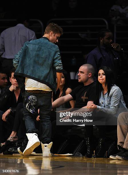 Justin Beiber leaves his courtside seat and girlfriend Selena Gomez durnig the game between the San Antonio Spurs and the Los Angeles Lakers at...