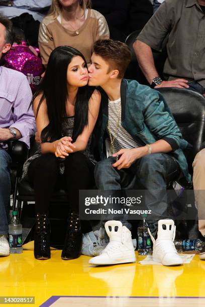 Selena Gomez and Justin Bieber kiss at a basketball game between the San Antonio Spurs and the Los Angeles Lakers at Staples Center on April 17, 2012...