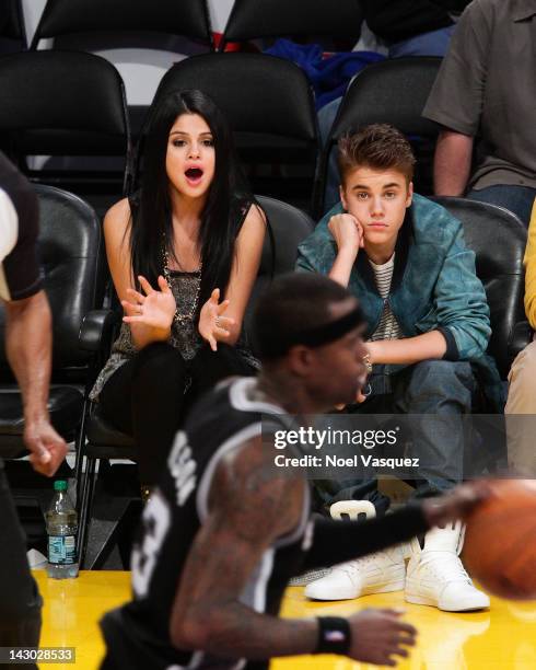 Selena Gomez and Justin Bieber attend a basketball game between the San Antonio Spurs and the Los Angeles Lakers at Staples Center on April 17, 2012...