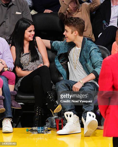 Selena Gomez and Justin Bieber attend a basketball game between the San Antonio Spurs and the Los Angeles Lakers at Staples Center on April 17, 2012...