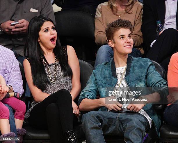 Selena Gomez and Justin Bieber attend a basketball game between the San Antonio Spurs and the Los Angeles Lakers at Staples Center on April 17, 2012...
