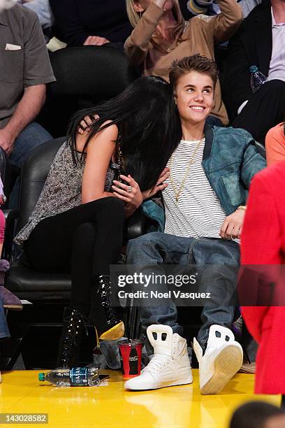 Selena Gomez and Justin Bieber attend a basketball game between the San Antonio Spurs and the Los Angeles Lakers at Staples Center on April 17, 2012...